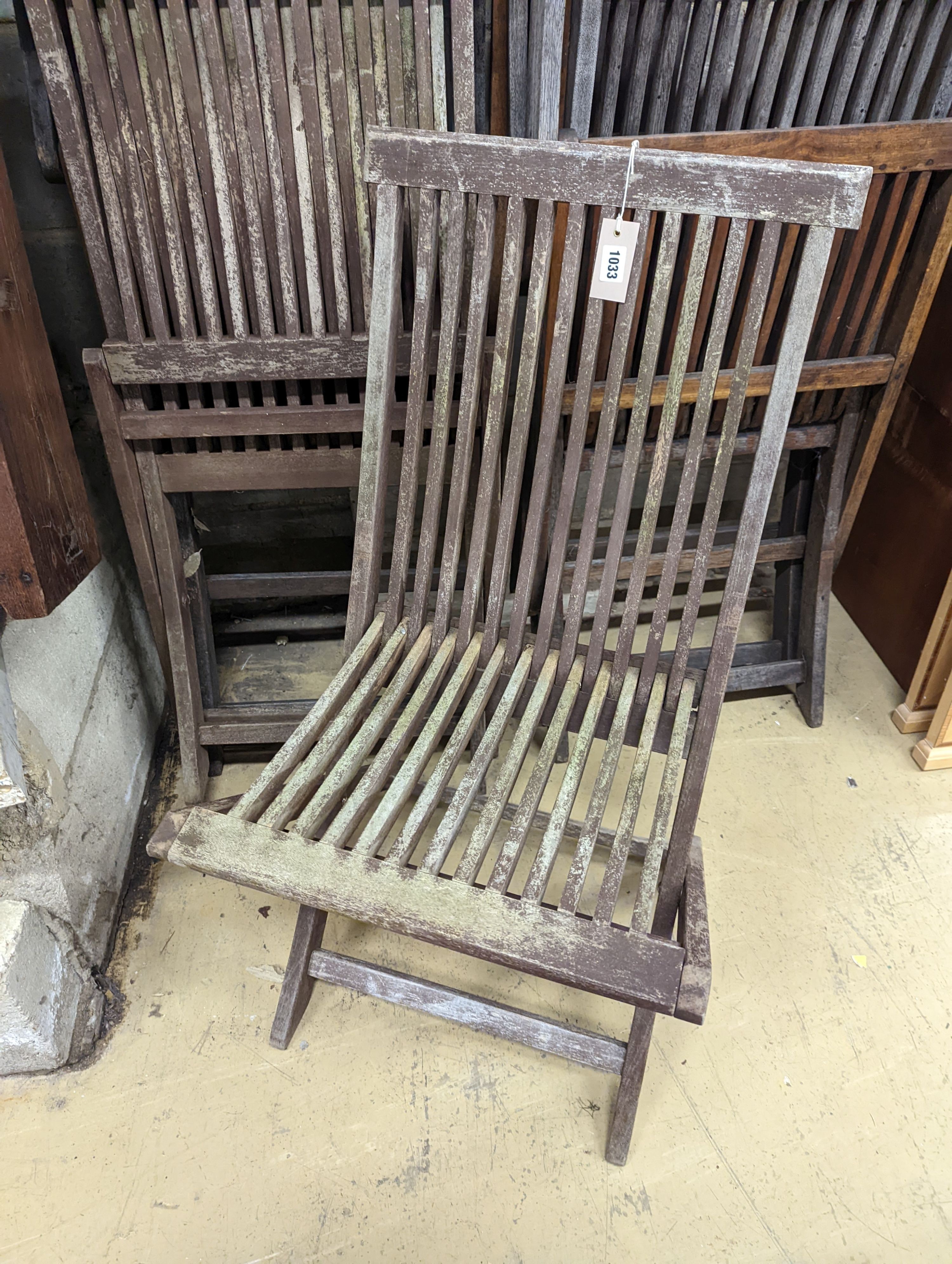 Five weathered teak folding garden chairs, three with arms